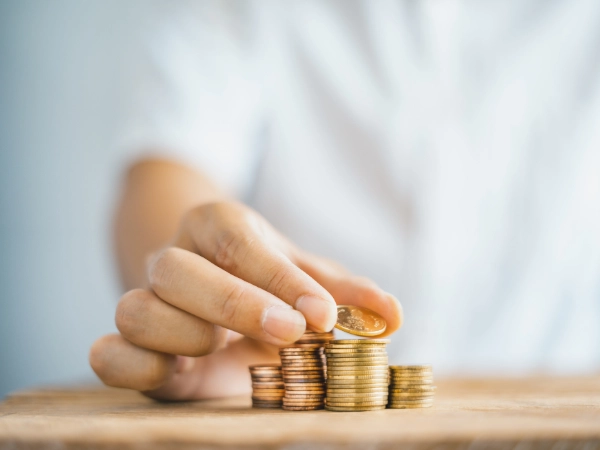 商品貸款換現金的情境輔佐圖，一隻手正在堆硬幣